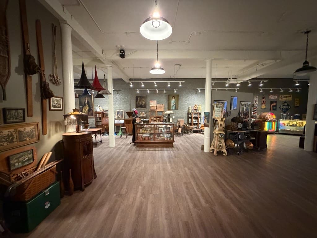 A gallery floor filled with vintage jukeboxes and historic objects at the Beautiful Things exhibition.