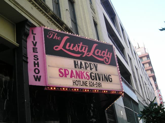 The Lusty Lady marquee on 1st Avenue in downtown Seattle, photographed at Thanksgiving 2005, with one of its famous punning announcements lit up above the entrance