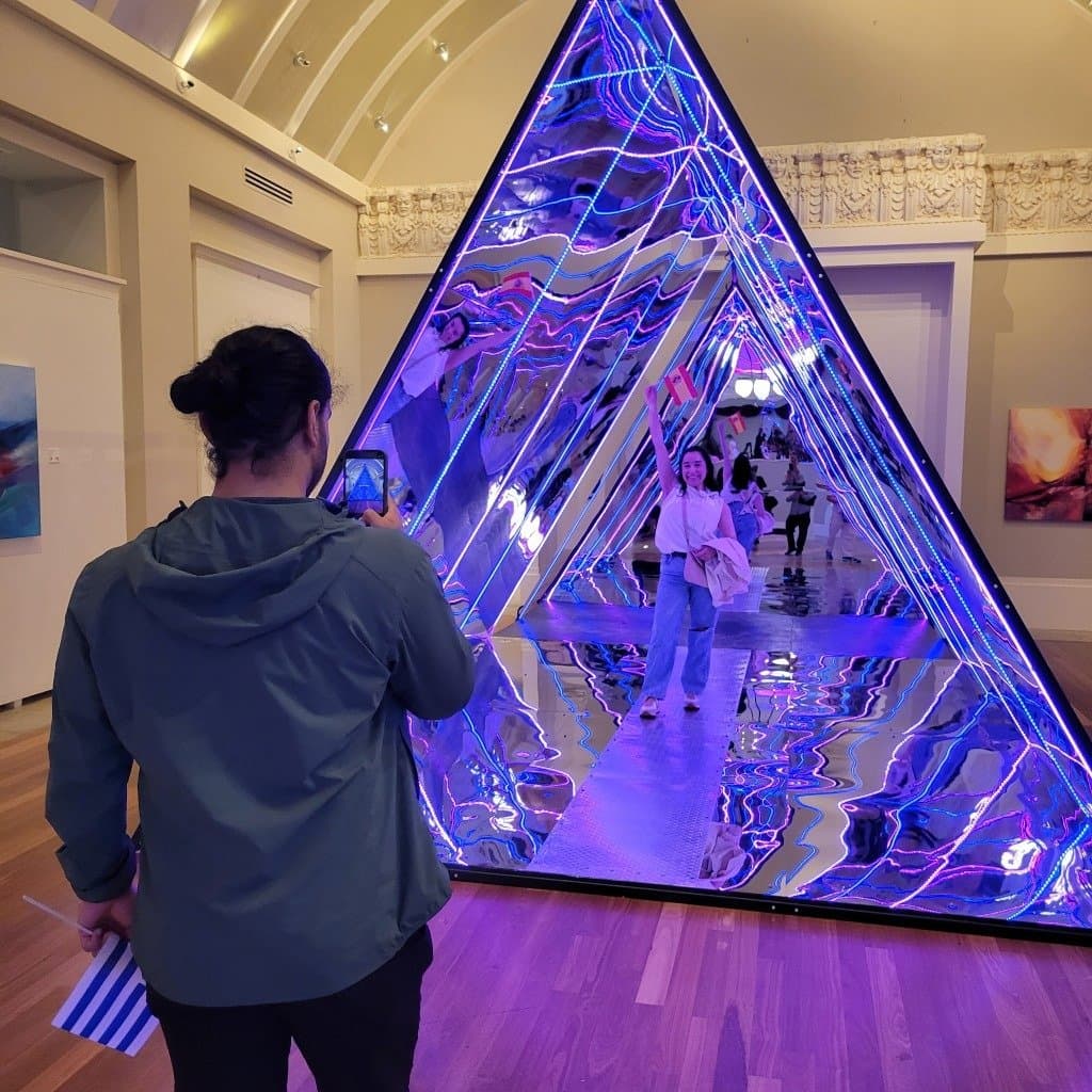 Visitors exploring the mirrored installation at the Coliseum of Art